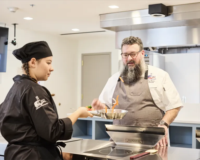 Culinary teacher observing students technique