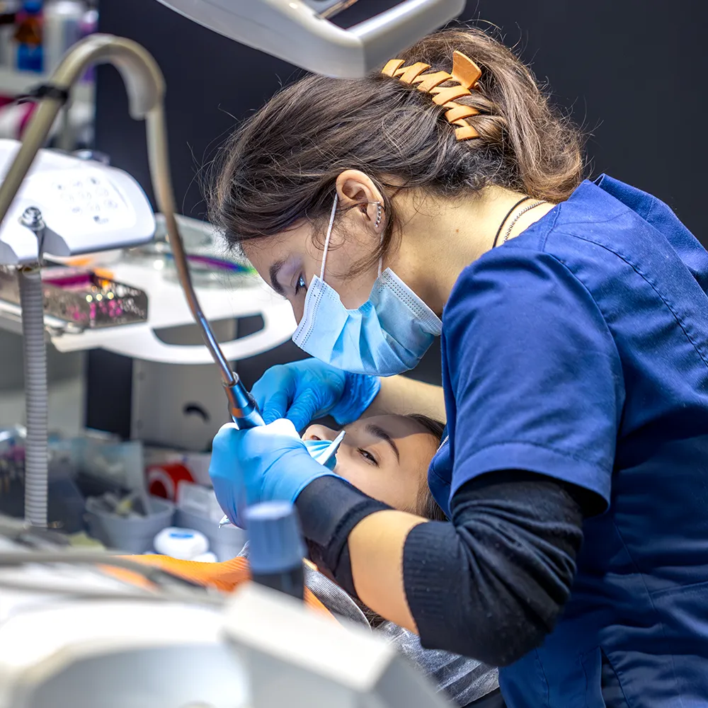 Dental student fixing teeth