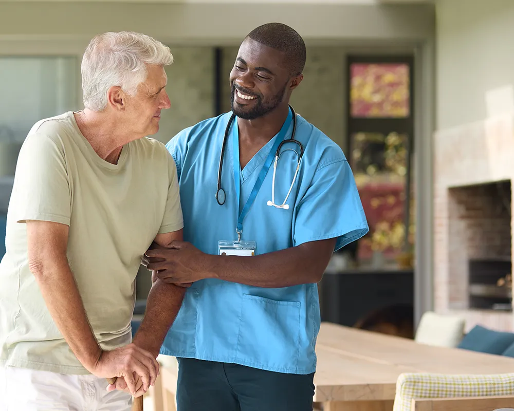 Nurse assisting elderly man