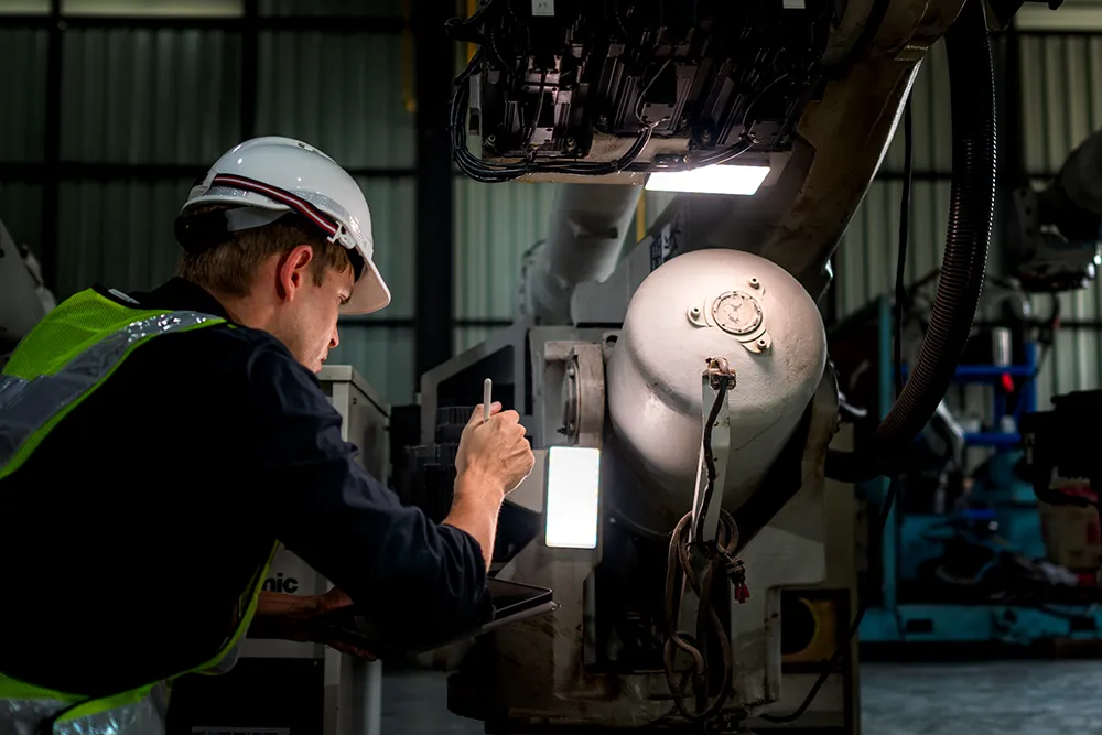 engineering student fixing machinery