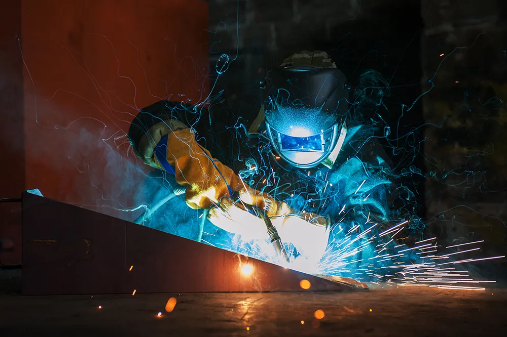 Welder welding metal together